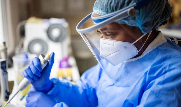 A researcher working in a biochemist's laboratory