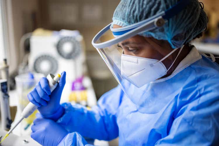 A researcher working in a biochemist's laboratory